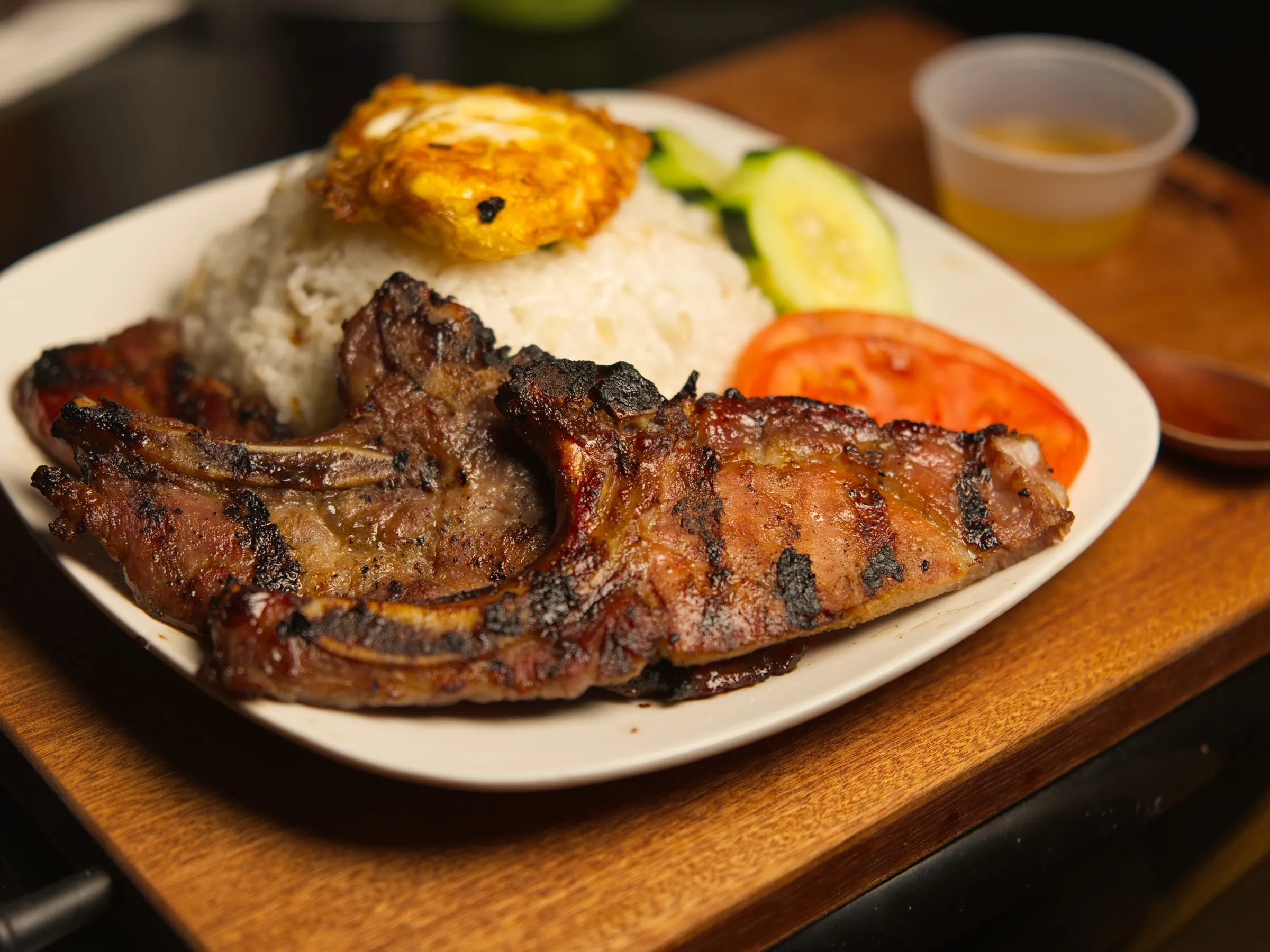 Charred grilled pork chops over garlic rice